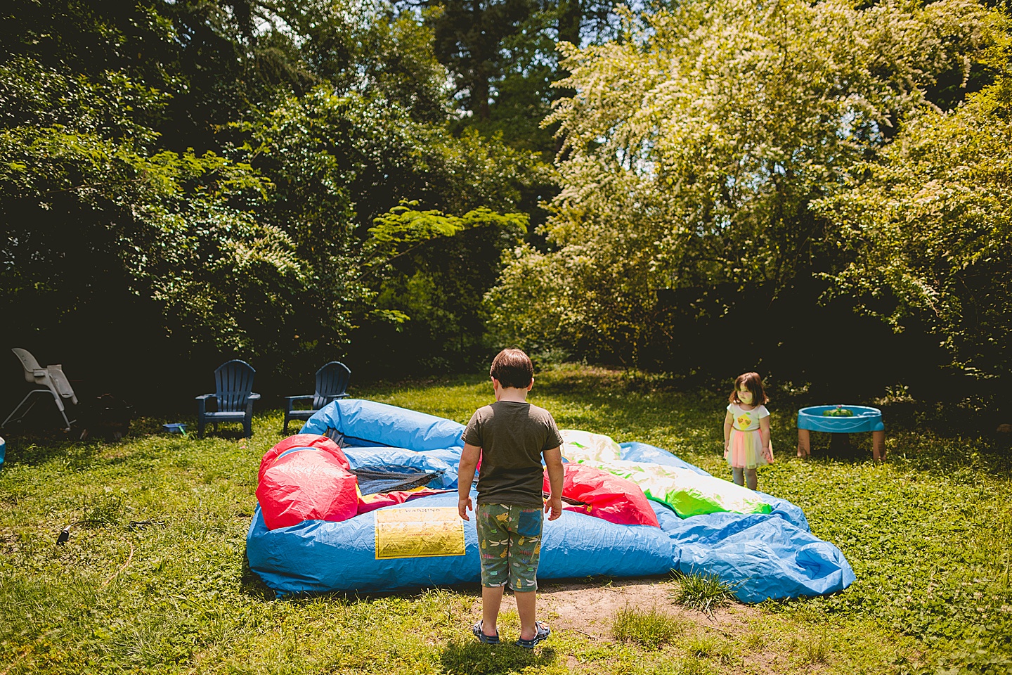 Kids go outside and stand by deflated bounce house