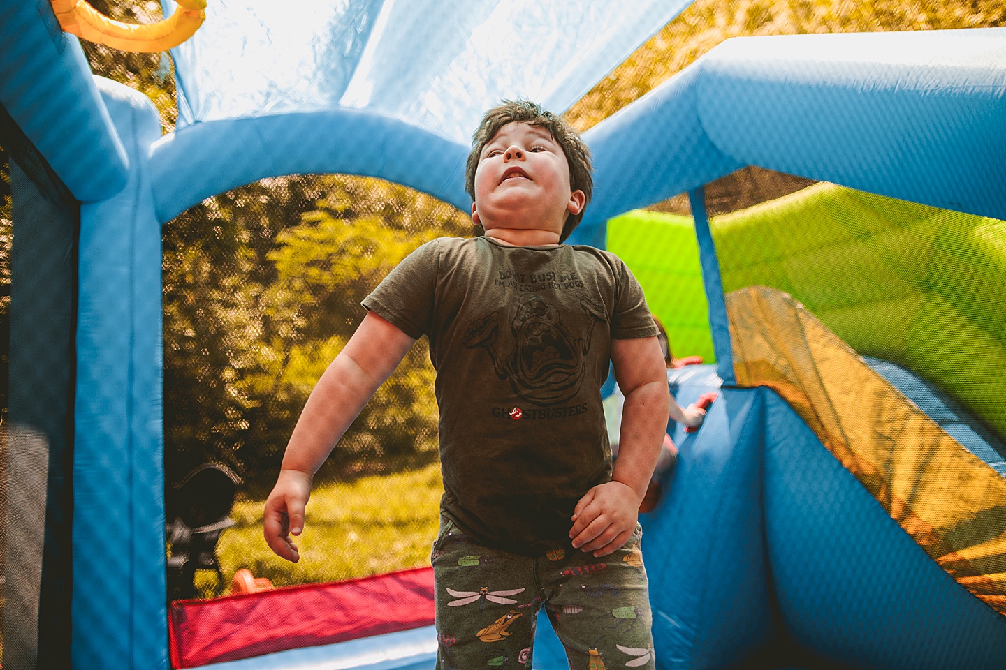 Family playing in bounce house during family photos in Durham