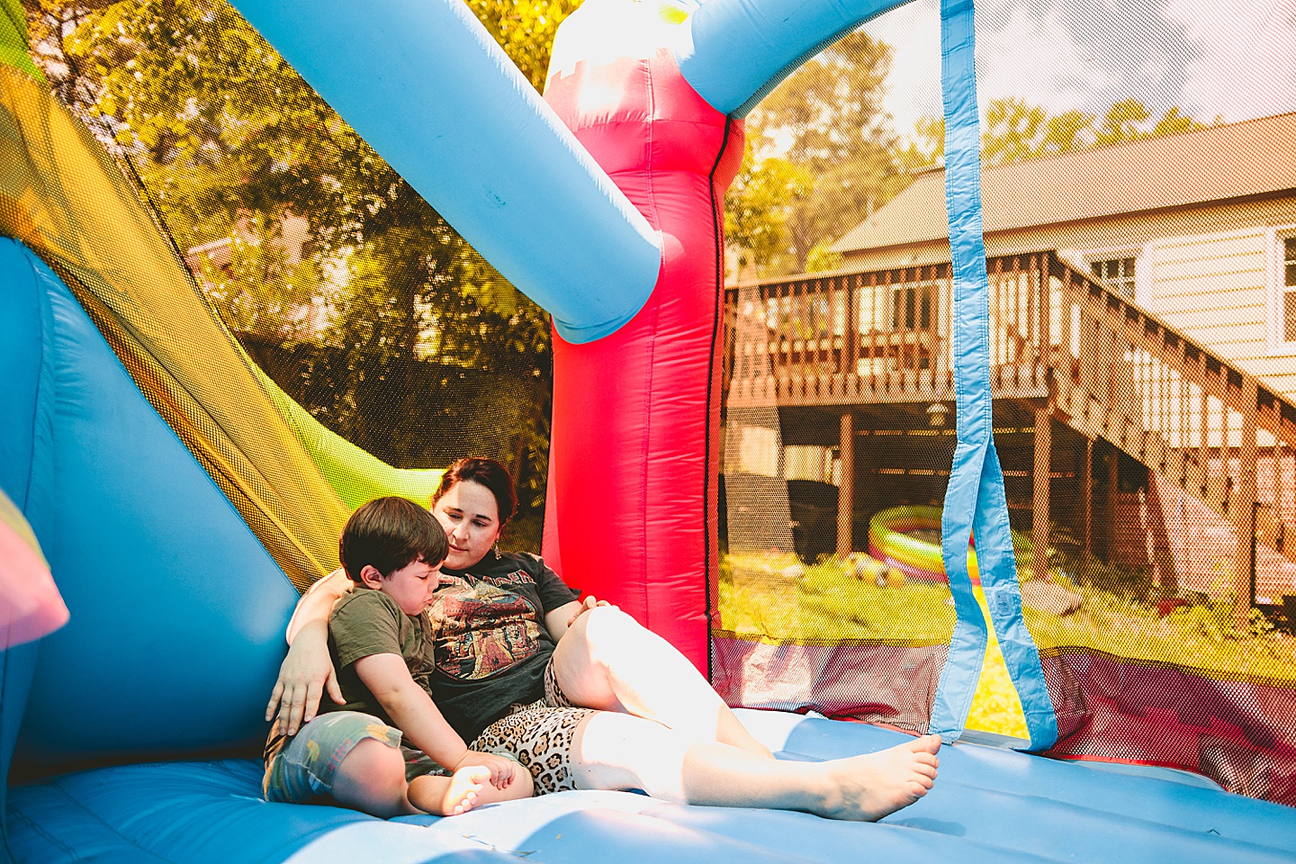 Family playing in bounce house during family photos in Durham