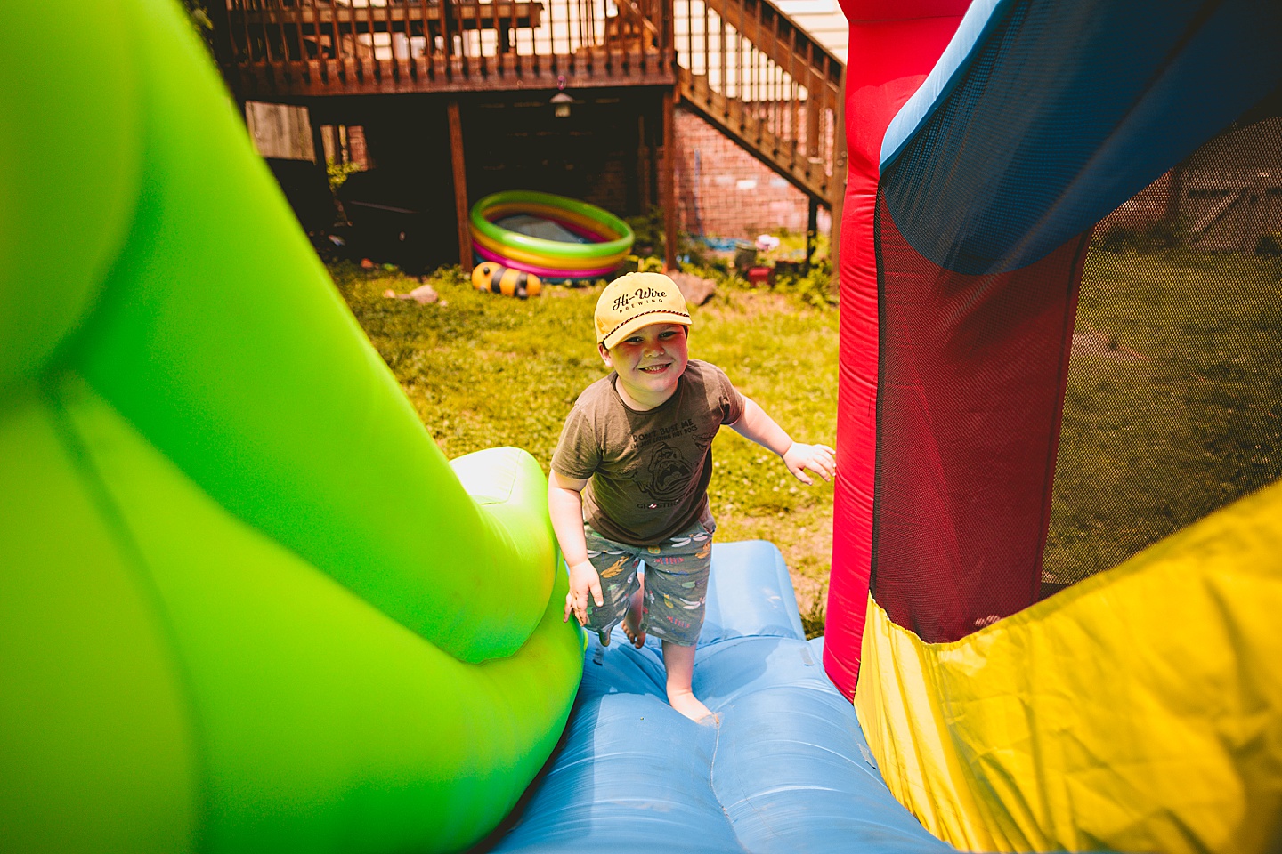 Family playing in bounce house during family photos in Durham