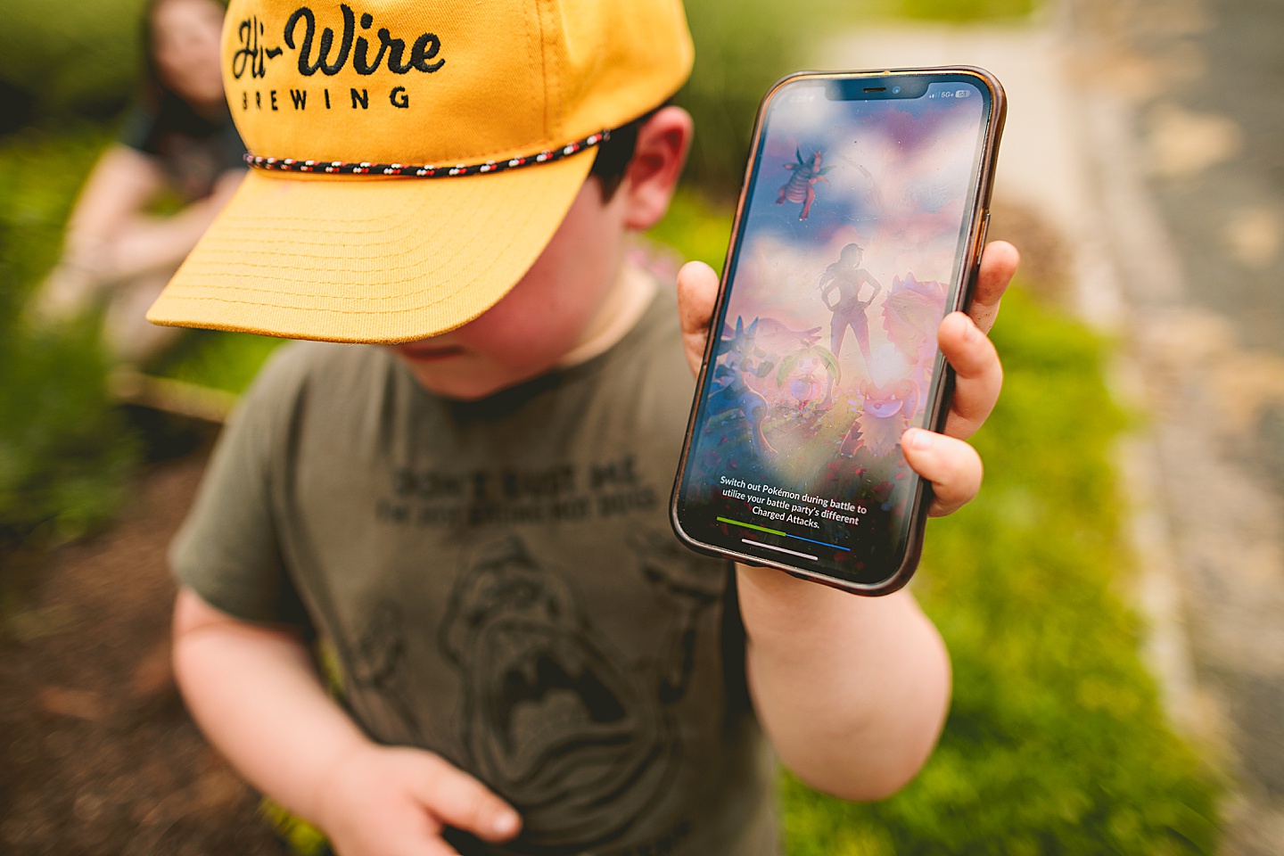 Kid playing Pokemon on his phone