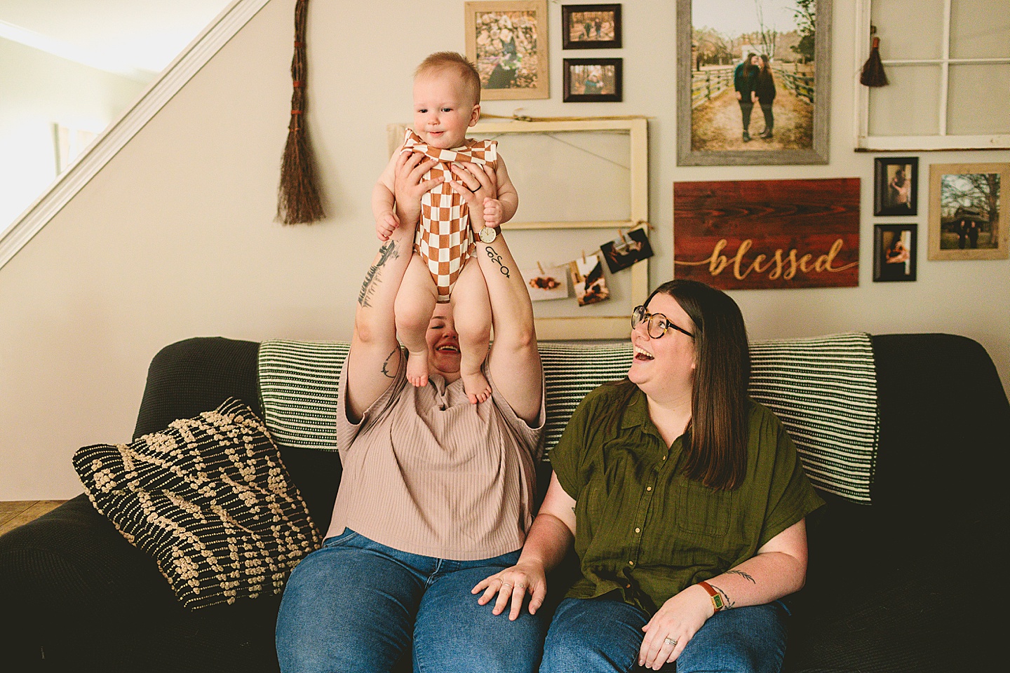 Moms holding baby on couch