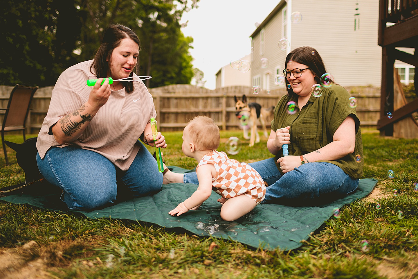 Women blowing bubbles for baby