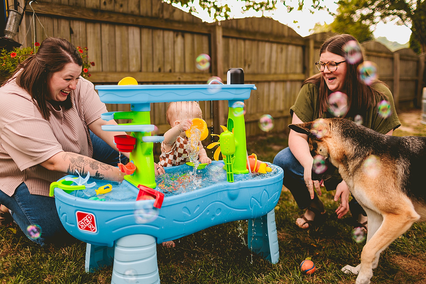 One year old baby plays at water table outside in NC