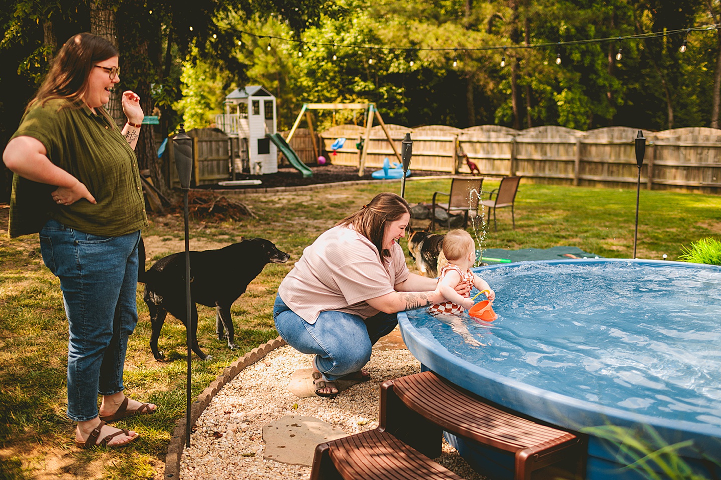 Baby playing in a pool with moms