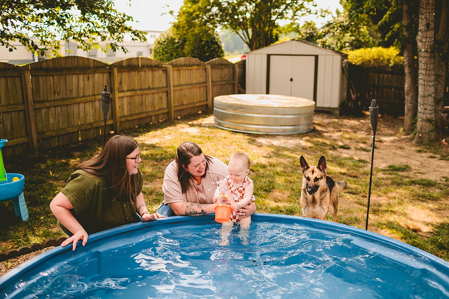 Baby playing in a pool with moms