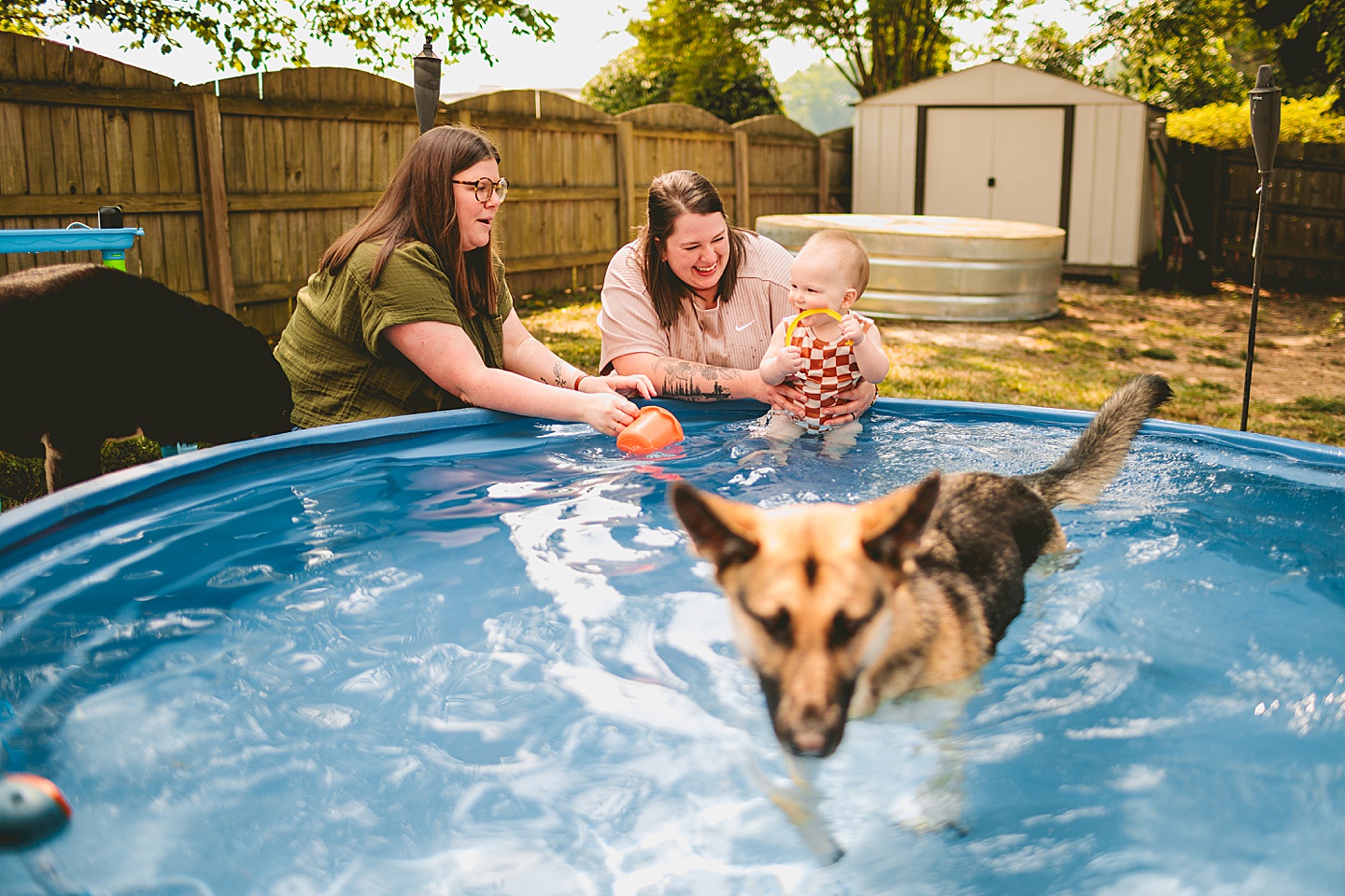 Baby playing in a pool with moms