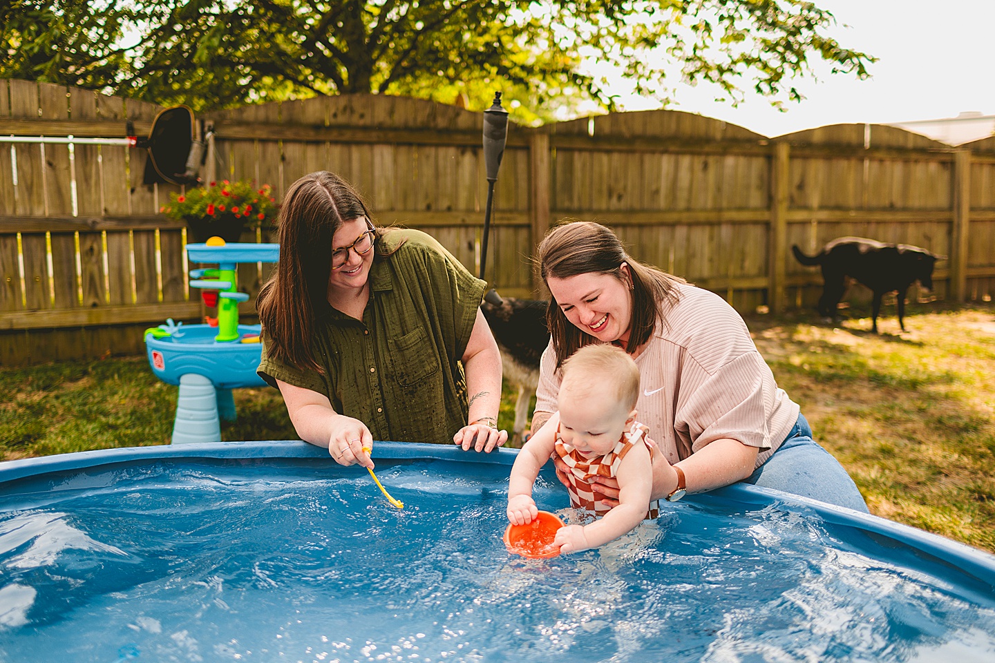 Baby playing in a pool with moms