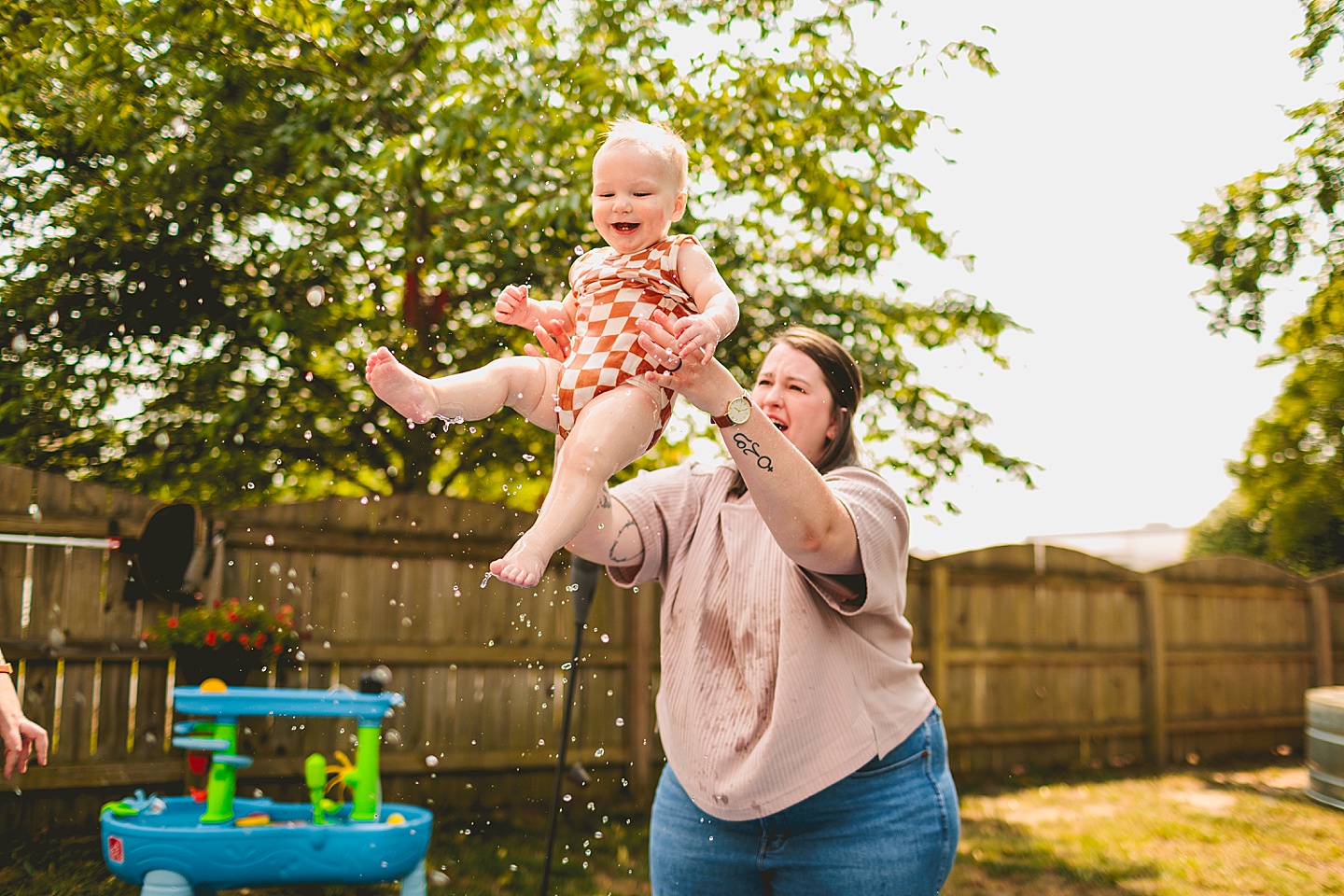 Baby playing in a pool with moms