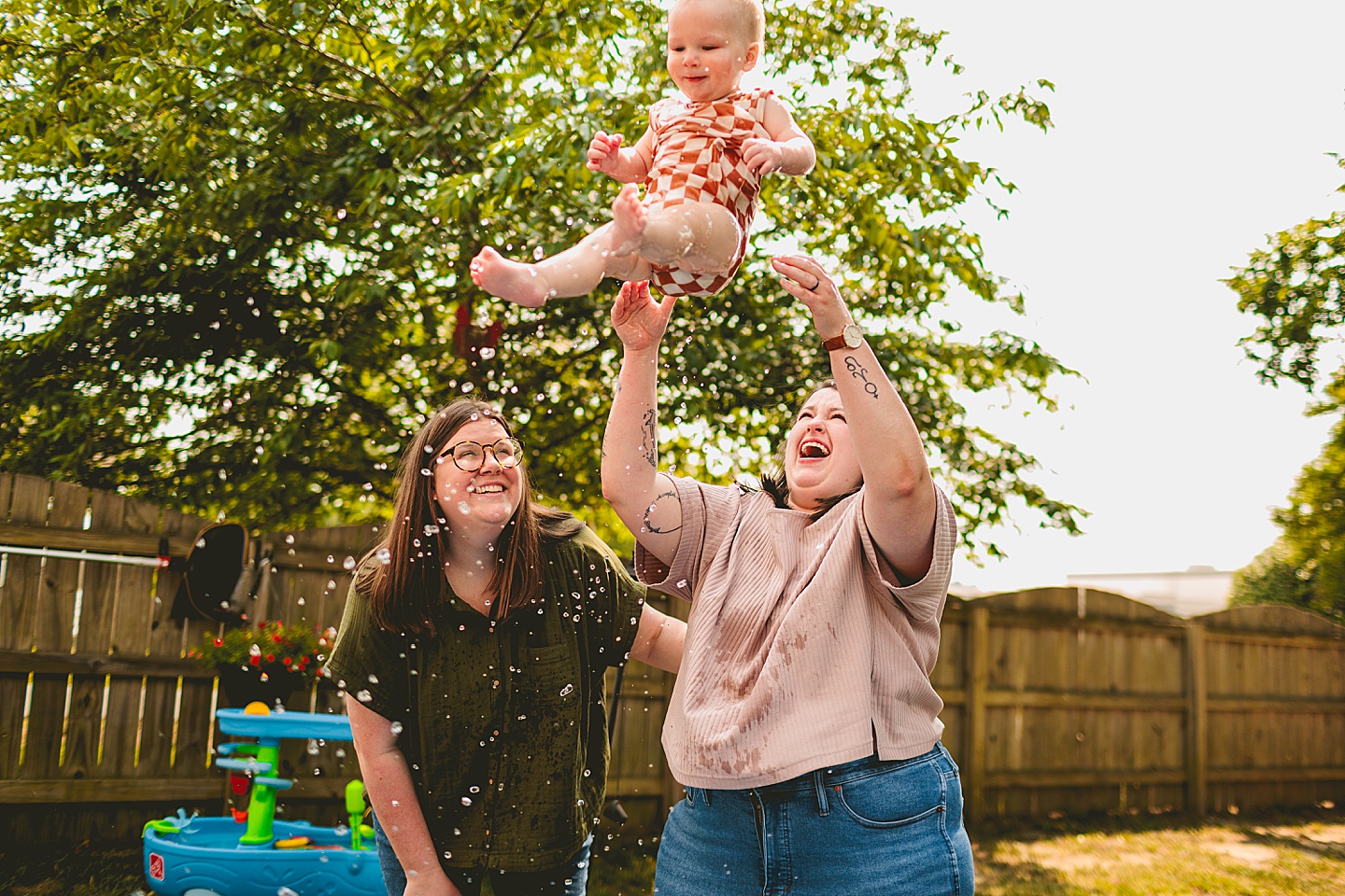 Baby playing in a pool with moms