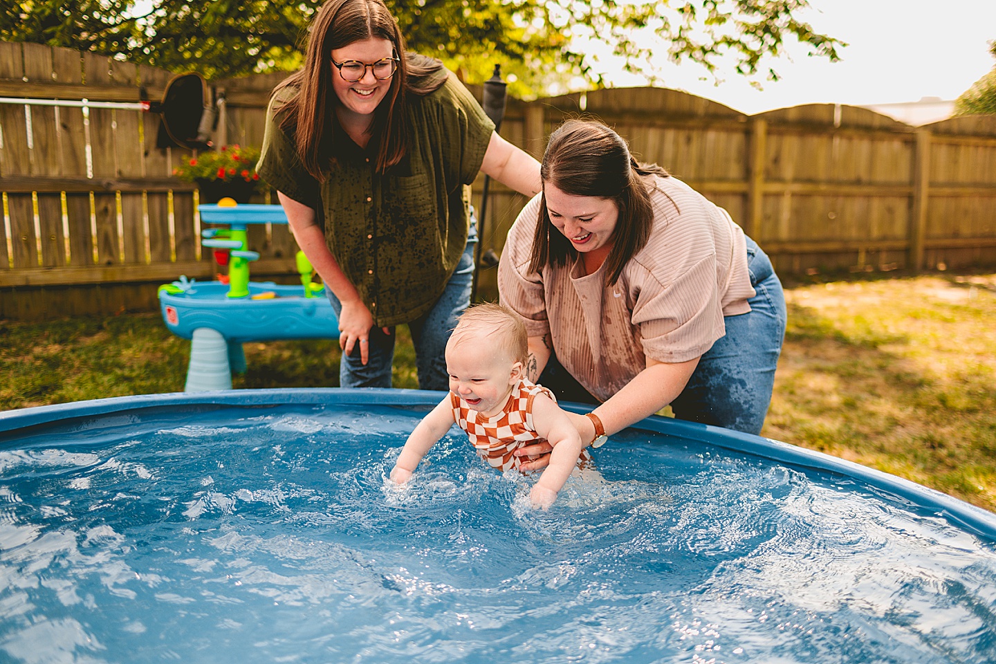 Baby playing in a pool with moms