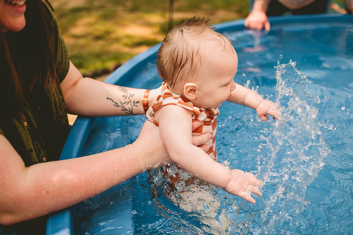 Baby playing in a pool with moms