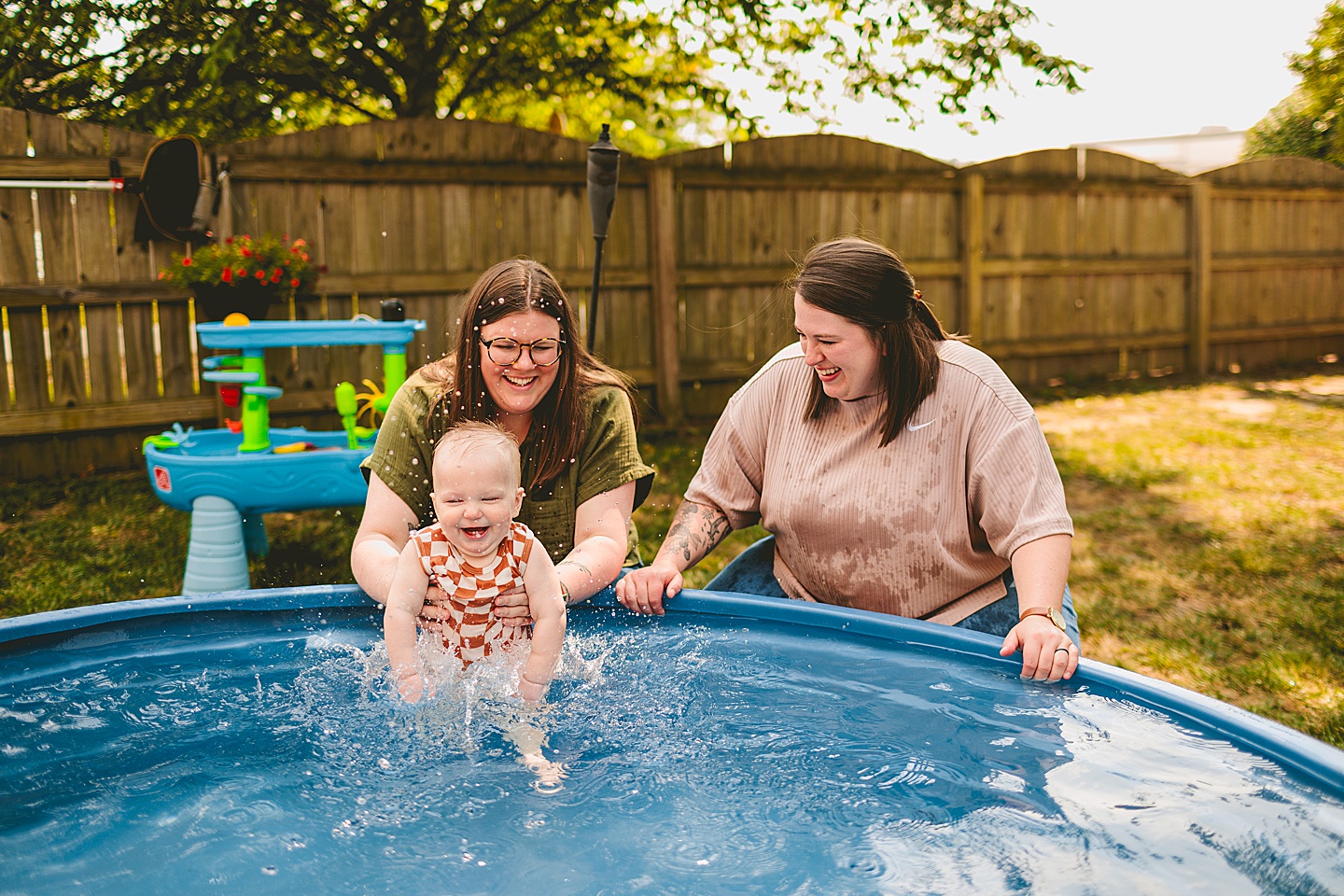 Baby playing in a pool with moms