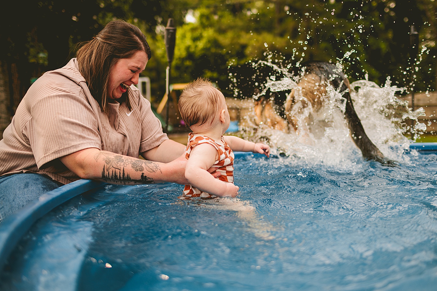 Baby playing in a pool with moms