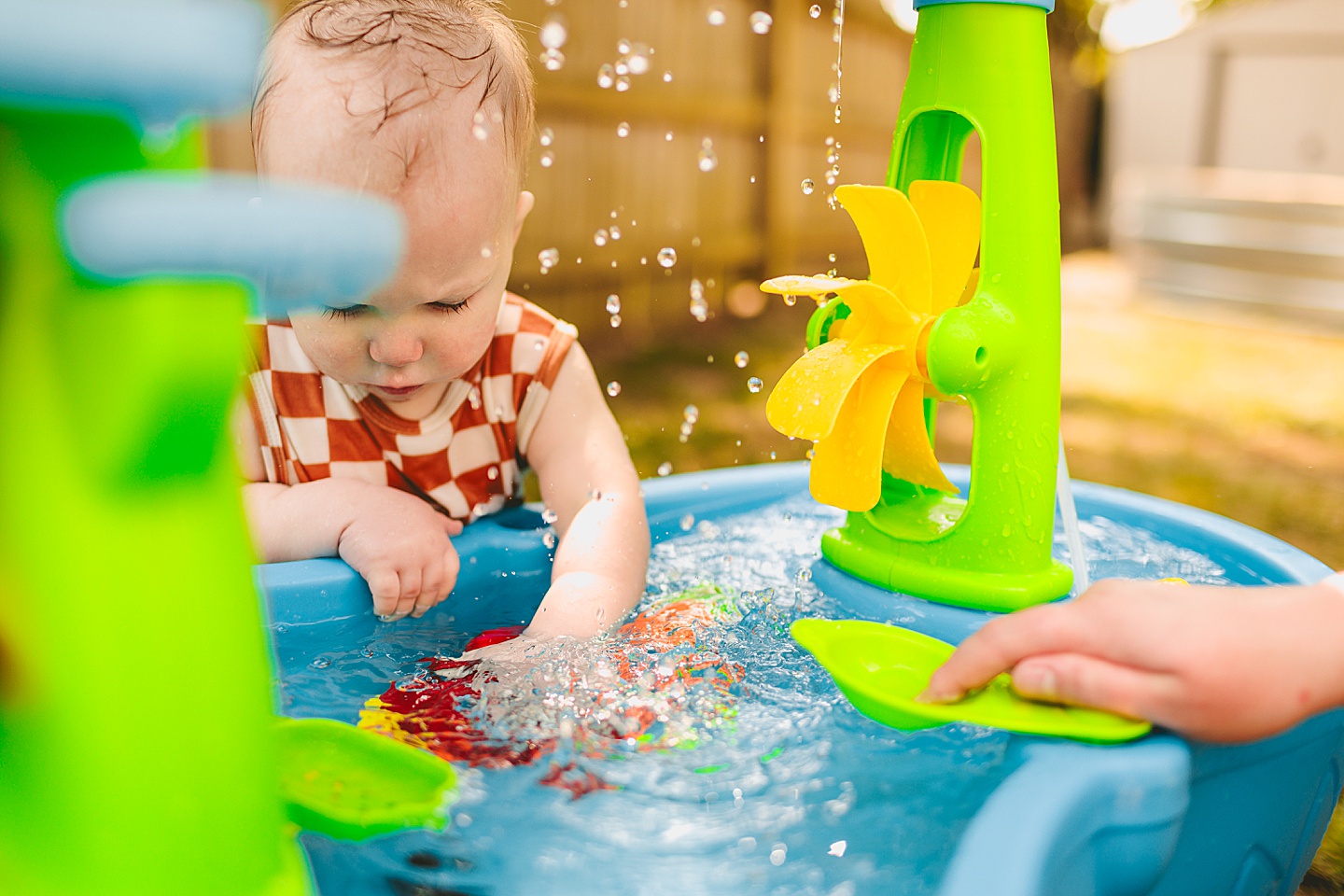 Baby using water table outside
