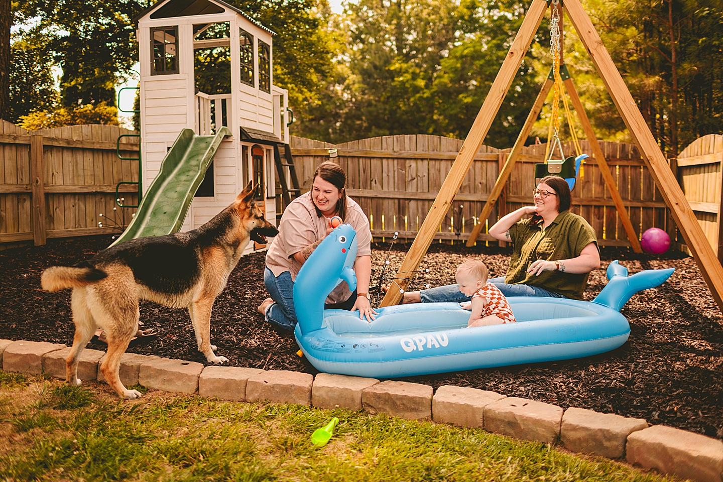 Parents watch baby in small kiddie pool