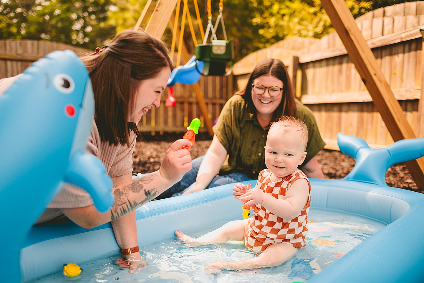 Parents watch baby in small kiddie pool