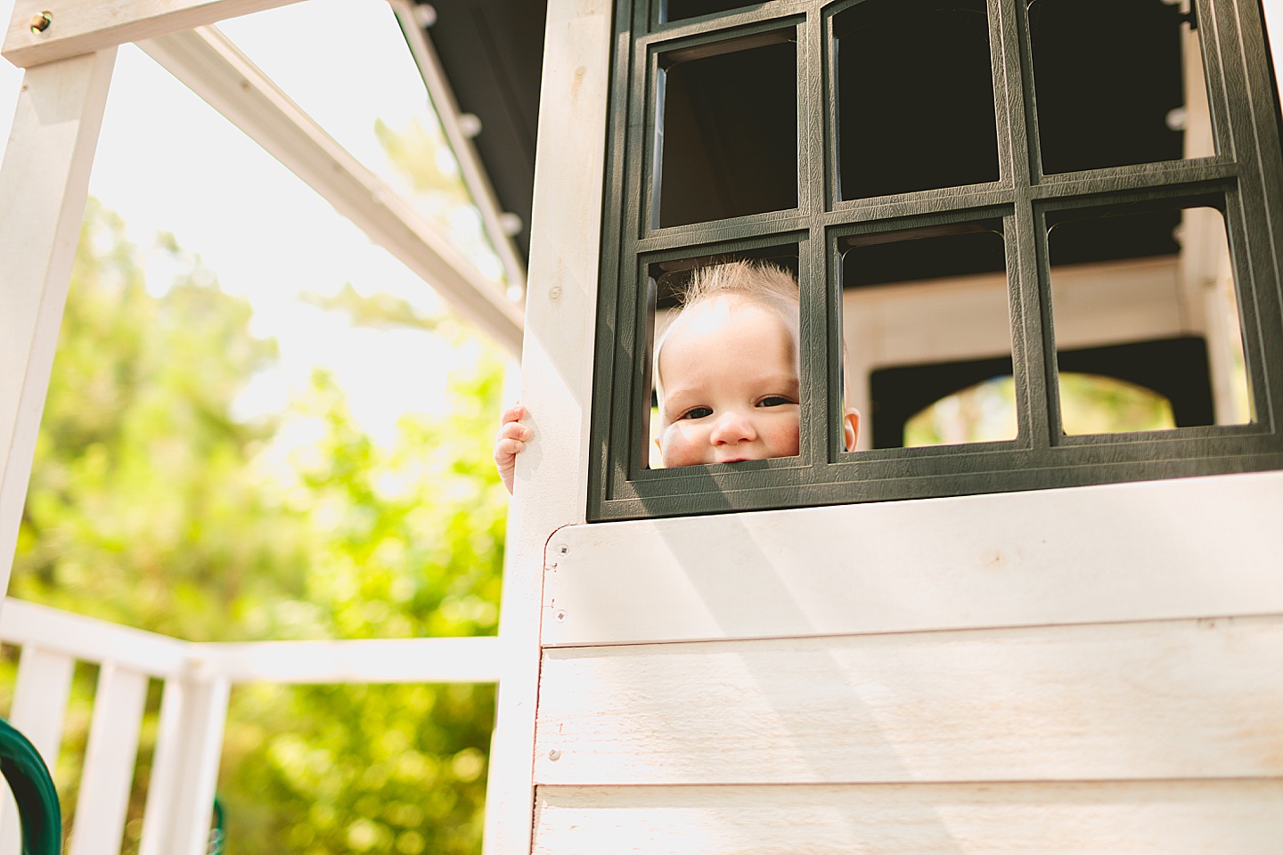 Baby smiling at treehouse