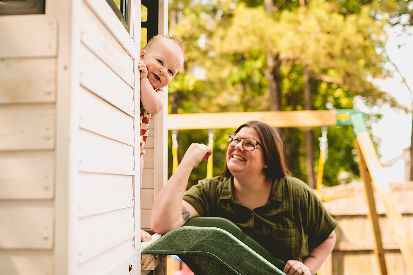 Baby smiling at treehouse