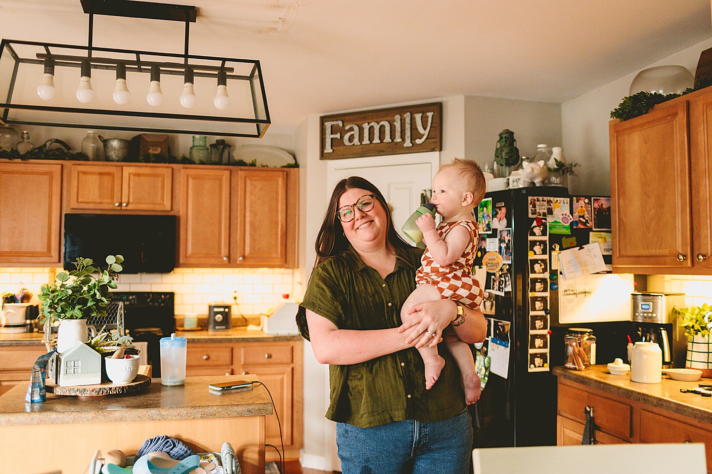 Mom holding baby in kitchen