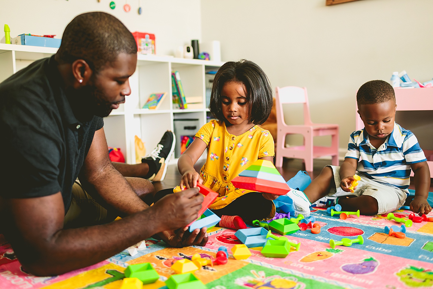 Dad playing Legos with kids