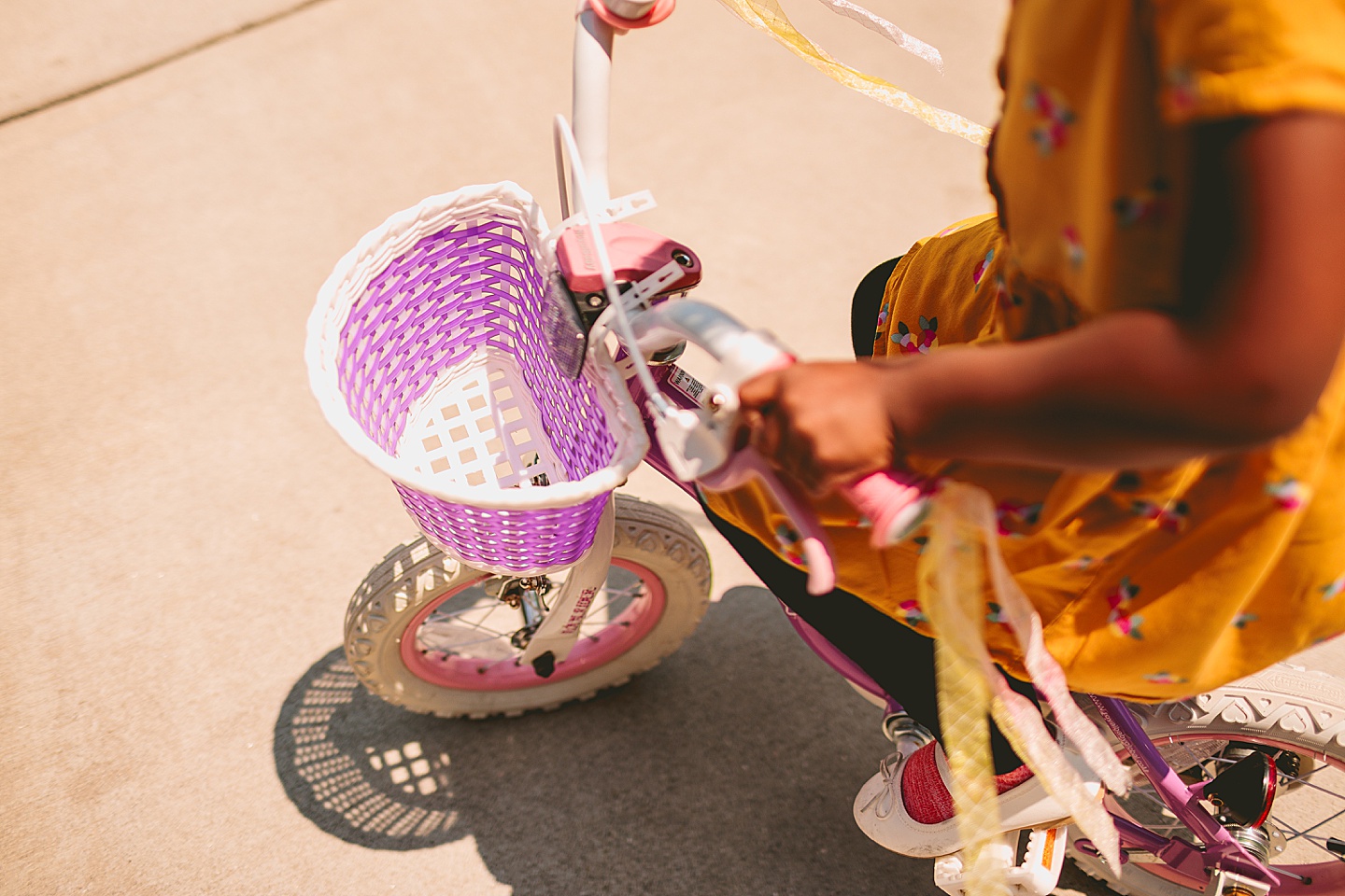 Kids riding bikes with their mom outside in the driveway