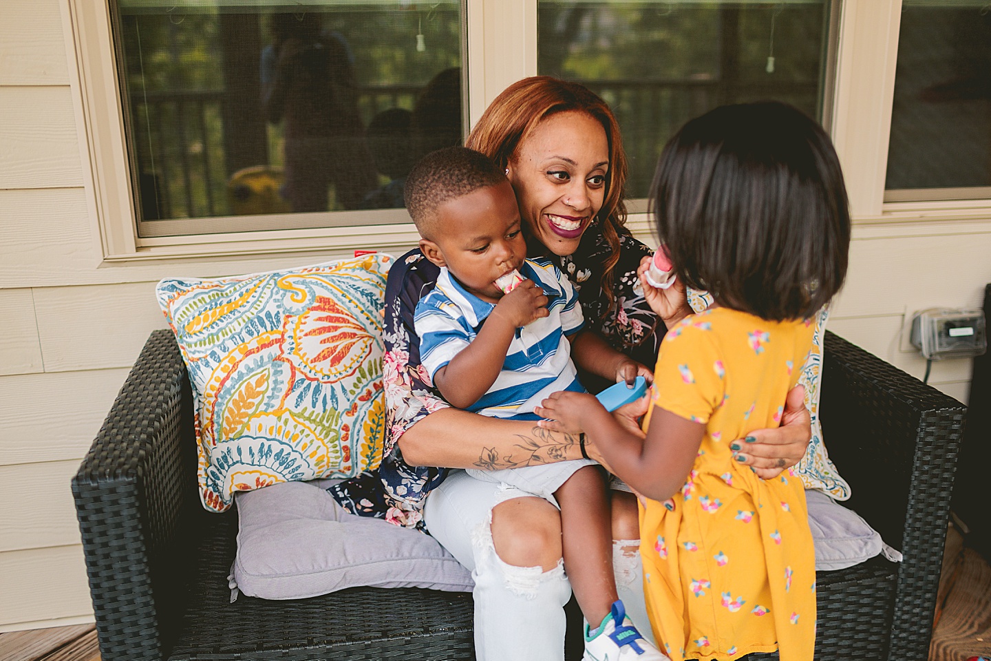 Kids eating popsicles on porch outside