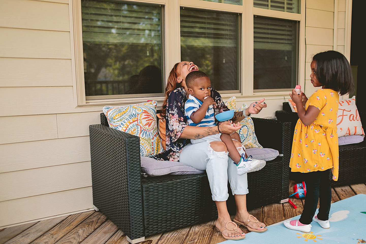 Kids eating popsicles on porch outside