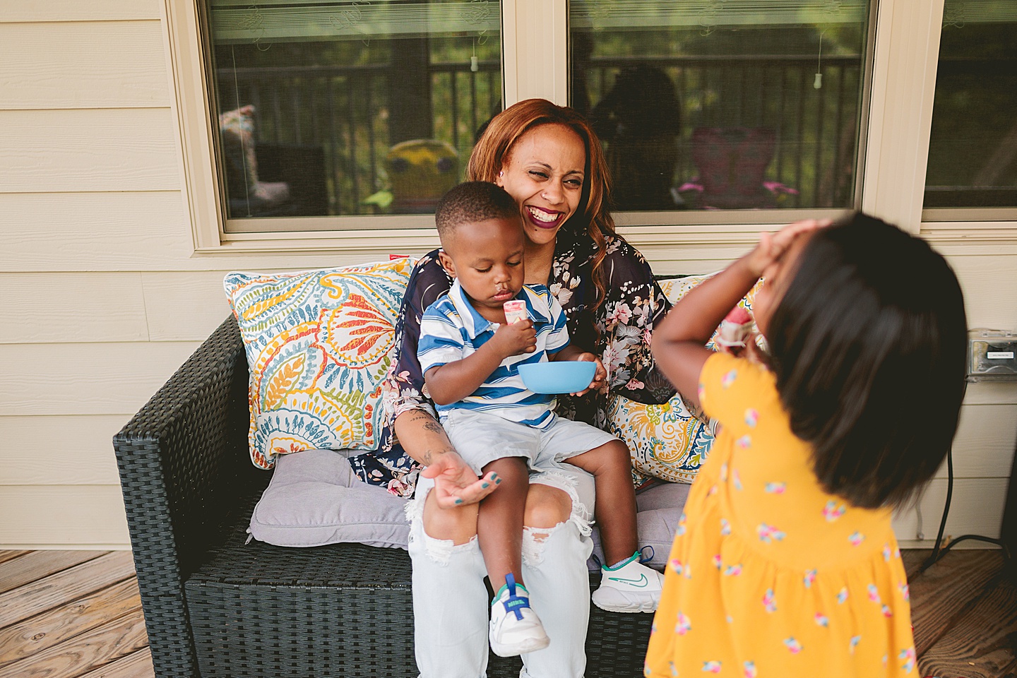 Kids eating popsicles on porch outside