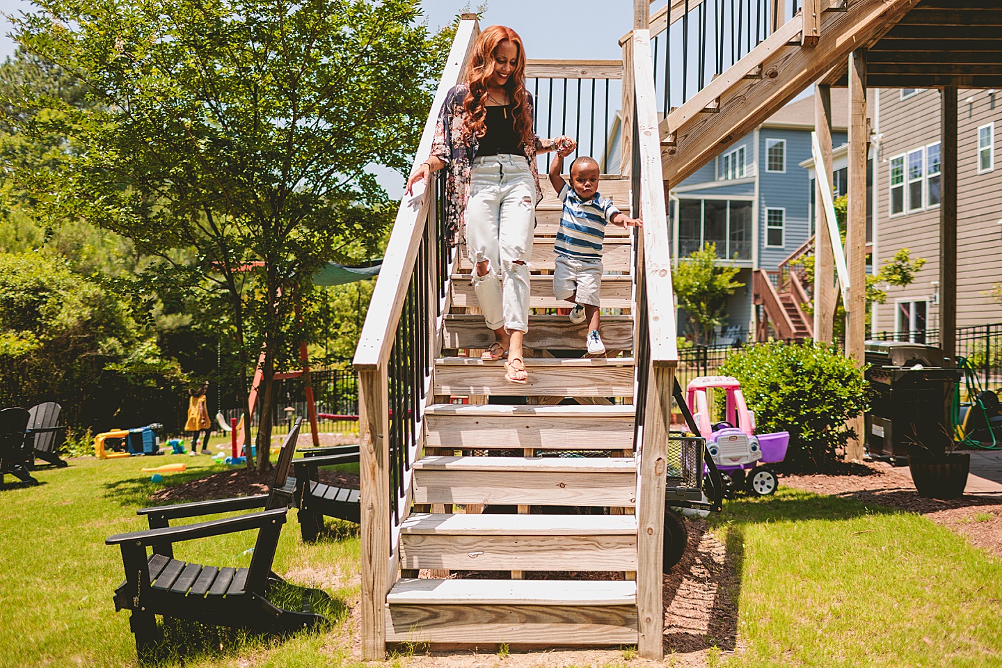 Mom and son walking down deck stairs