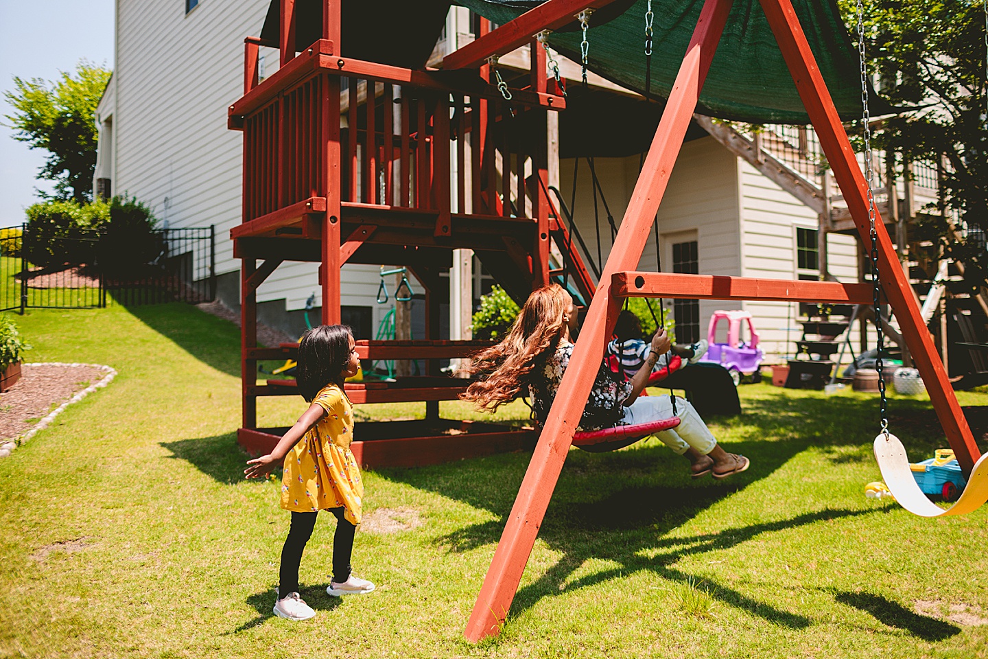 Kids swinging in backyard