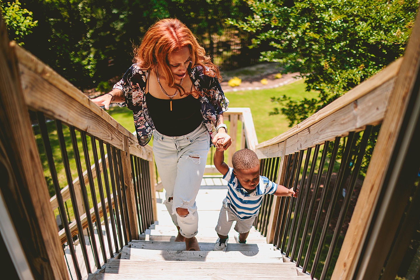 Mom walking with kid up the stairs