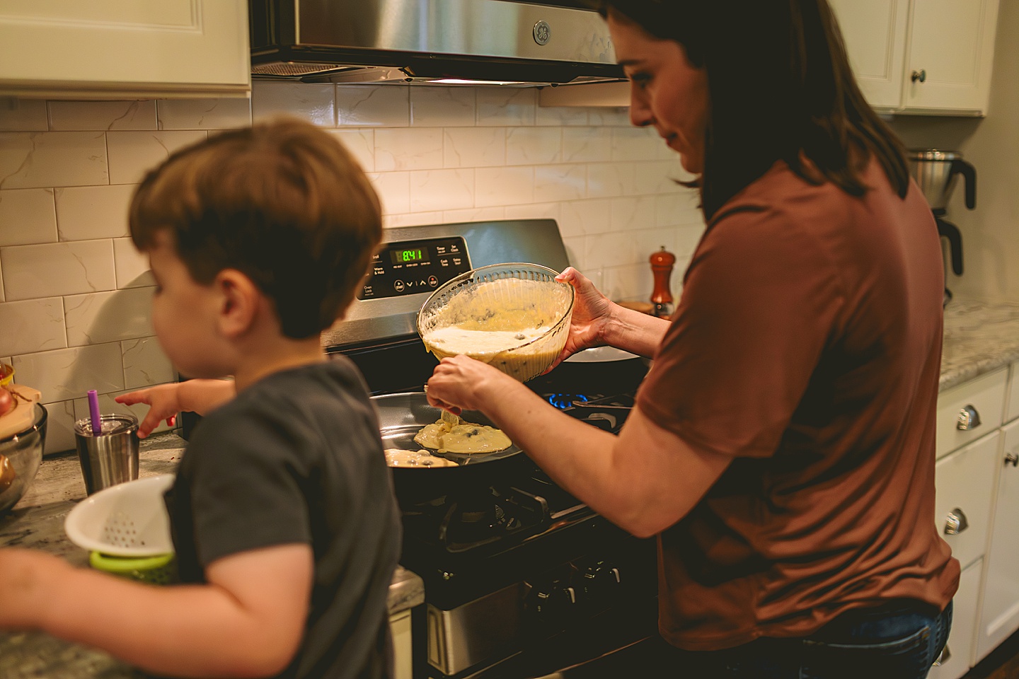 Family making breakfast in kitchen together