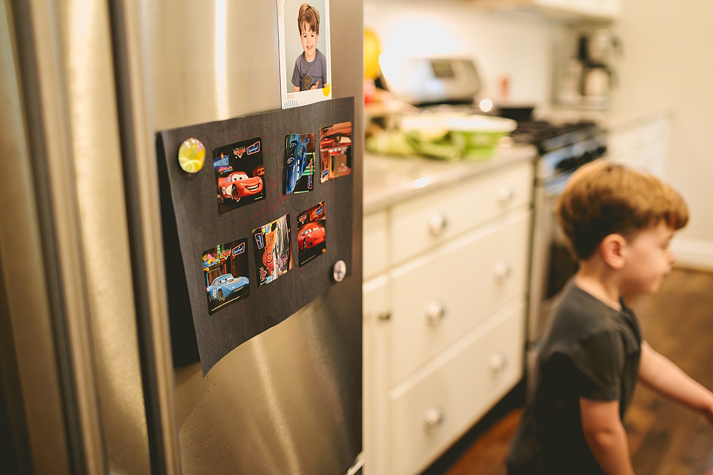 Picture of cars on fridge held up with magnet
