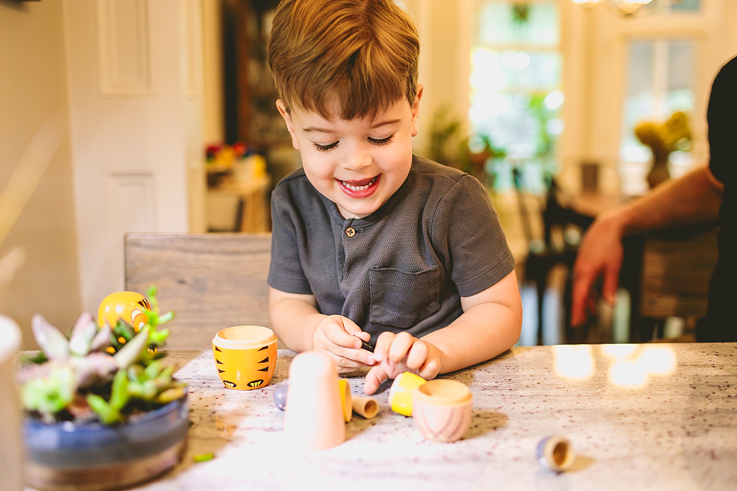 Child playing with toy nesting dolls