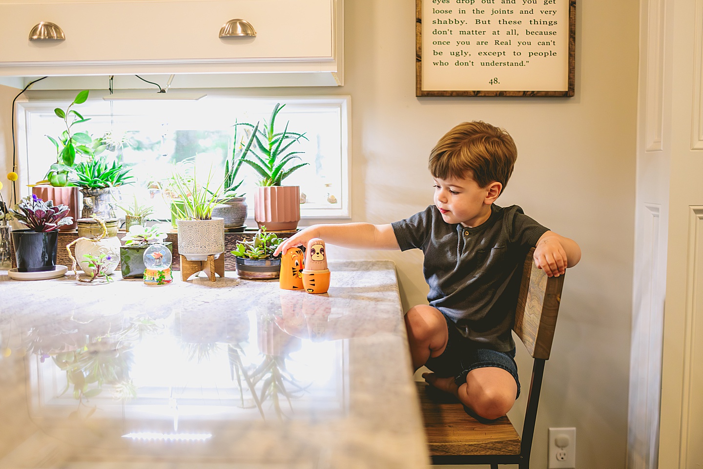 Child playing with toy nesting dolls