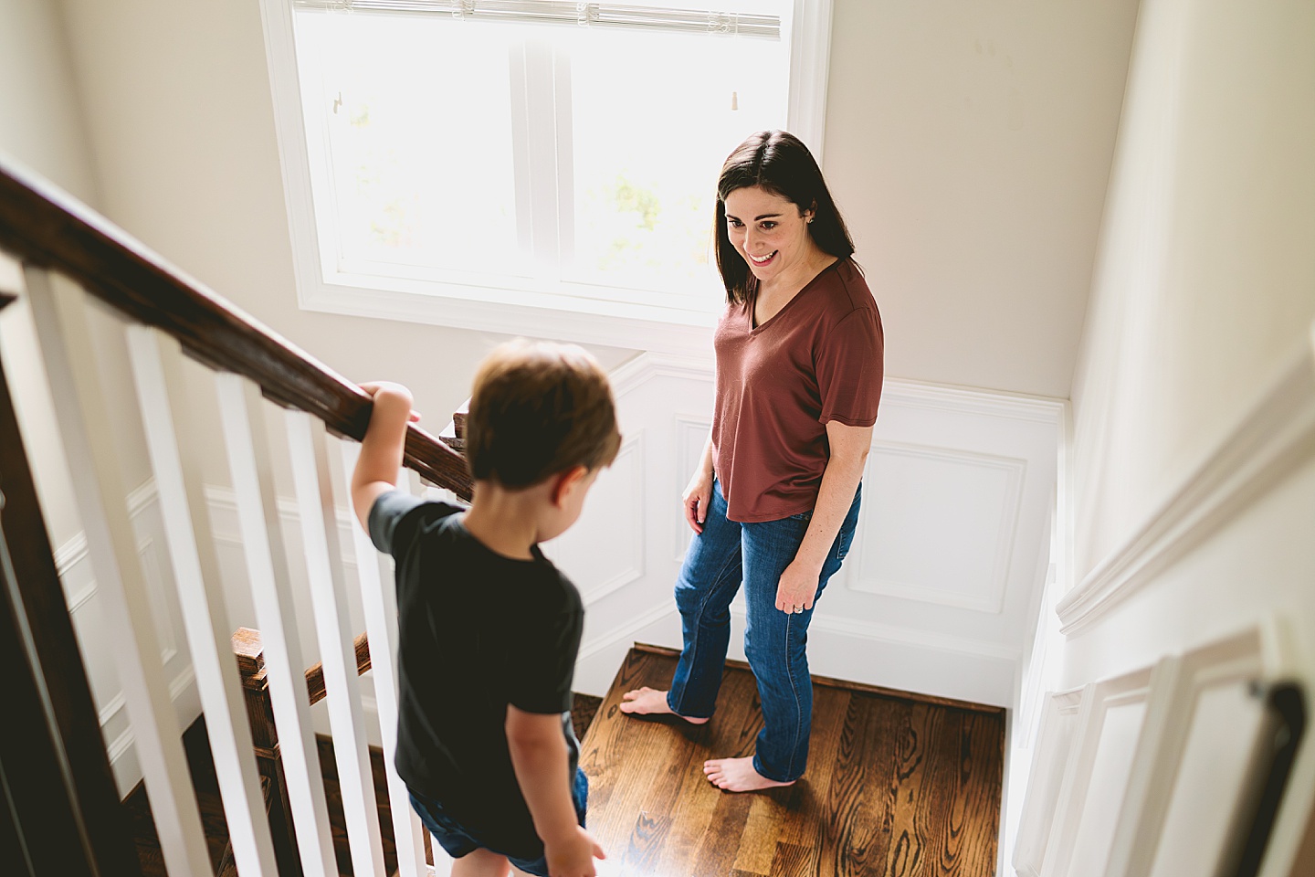 Mom walking down the stairs with toddler
