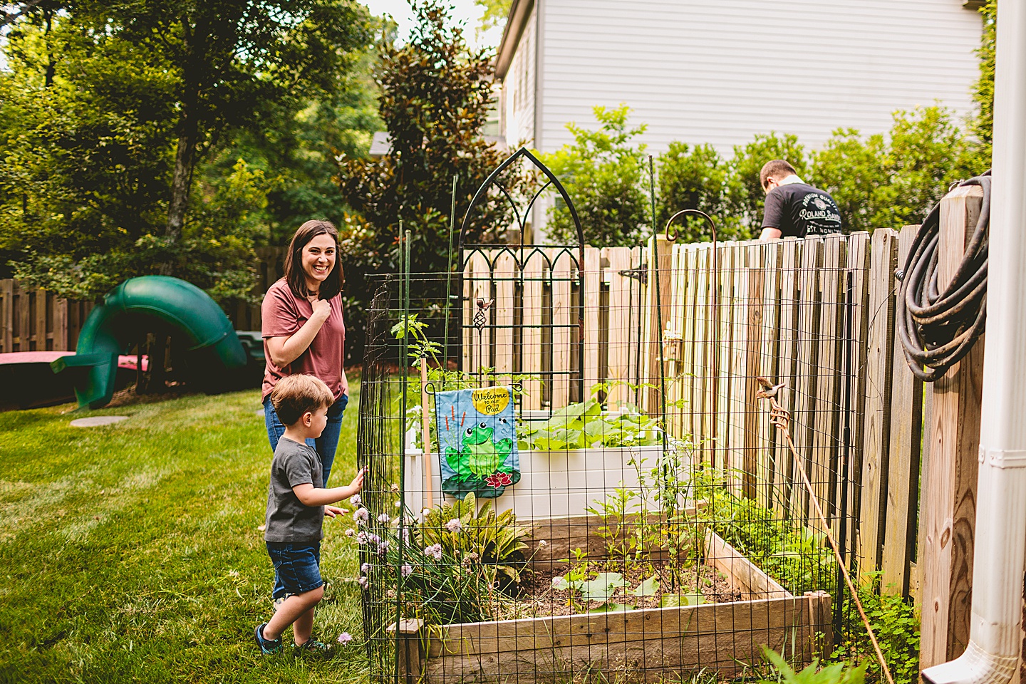 Child walking with his mom through the garden