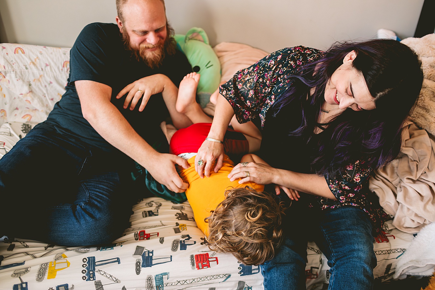 At home family photos of mom and dad wrestling with child