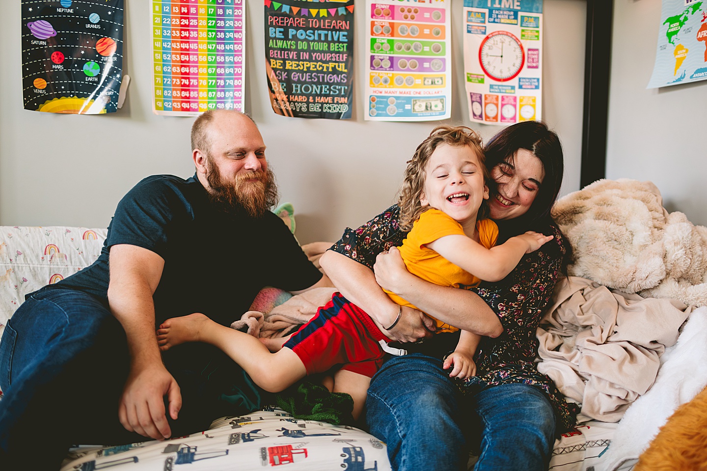 At home family photos of mom and dad wrestling with child