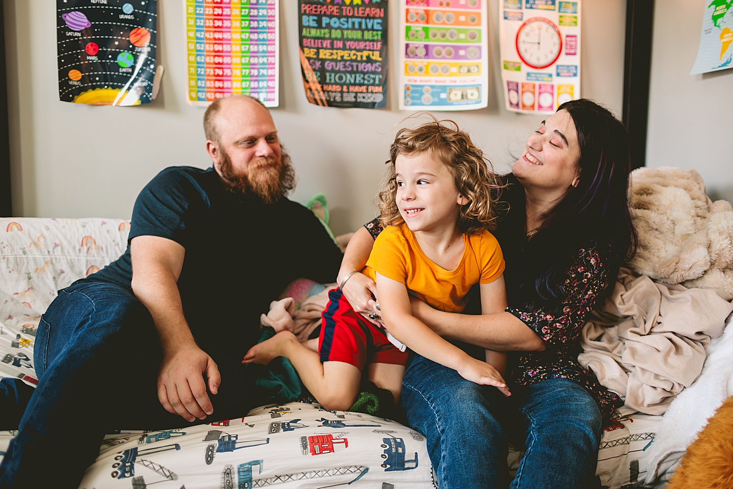 At home family photos of mom and dad wrestling with child