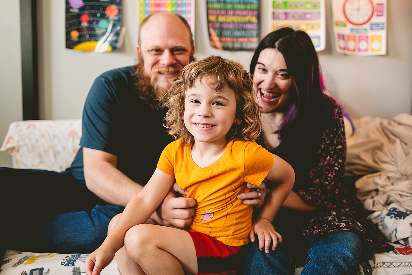 At home family photos of mom and dad wrestling with child