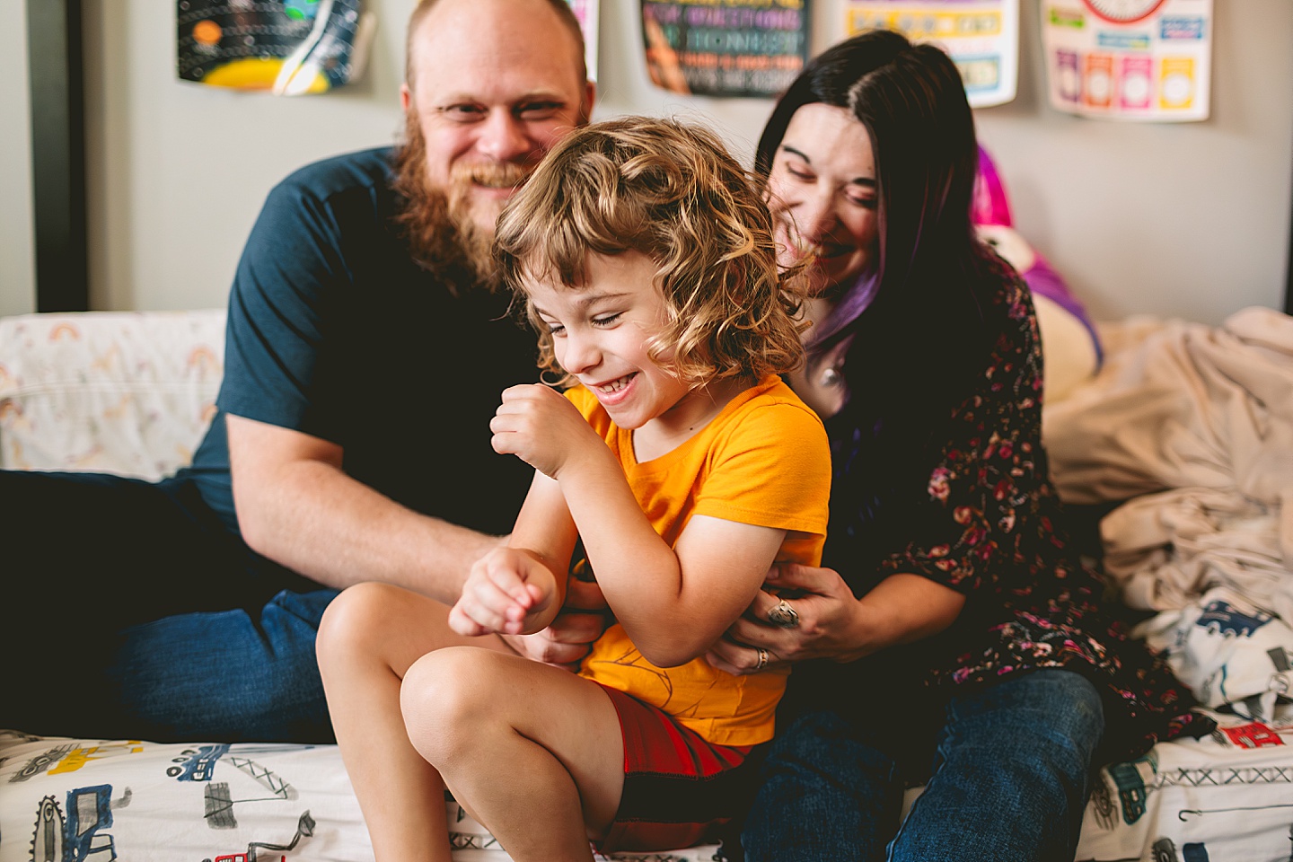 At home family photos of mom and dad wrestling with child