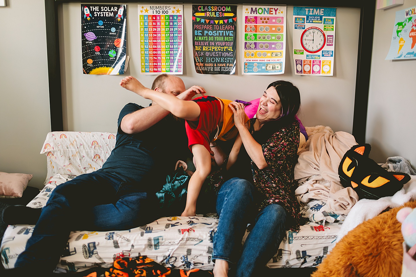 At home family photos of mom and dad wrestling with child