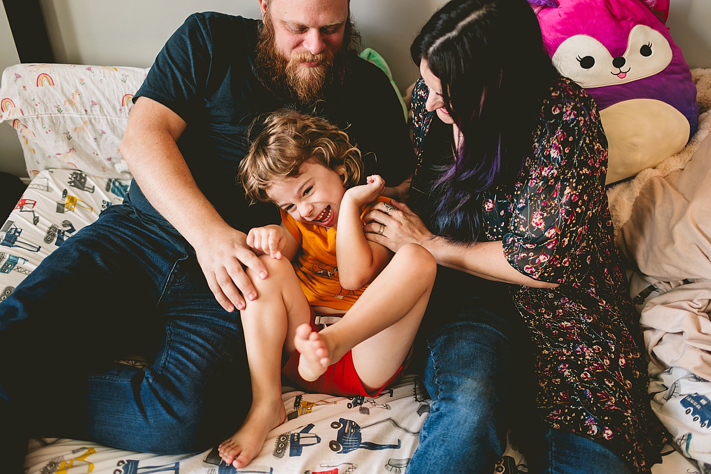 At home family photos of mom and dad wrestling with child