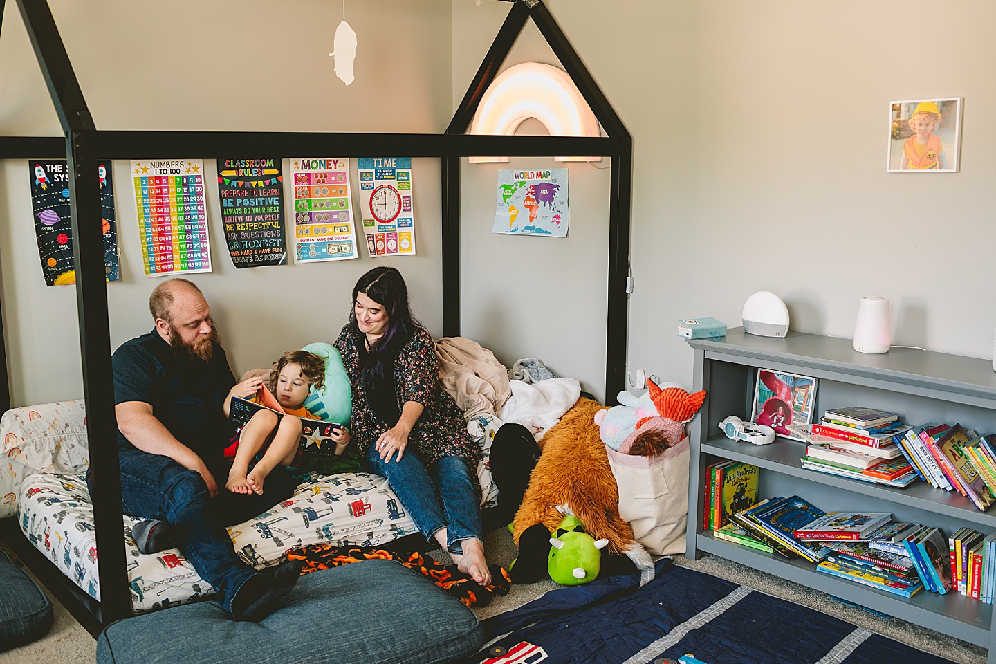 Parents reading to child in bed