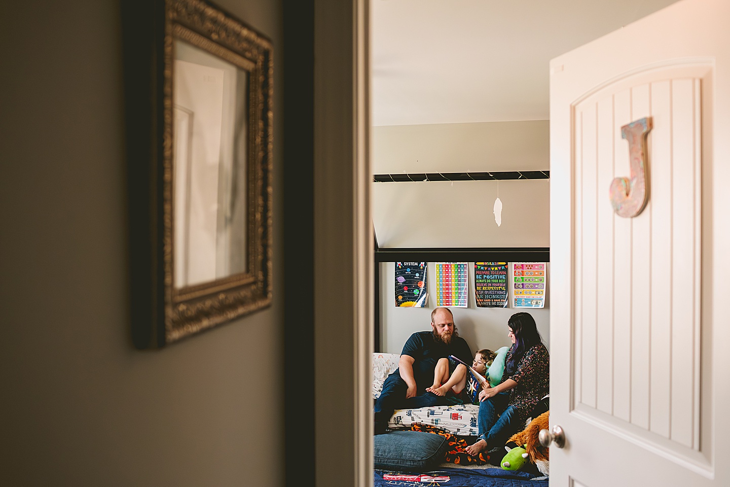 Parents reading to child in bed