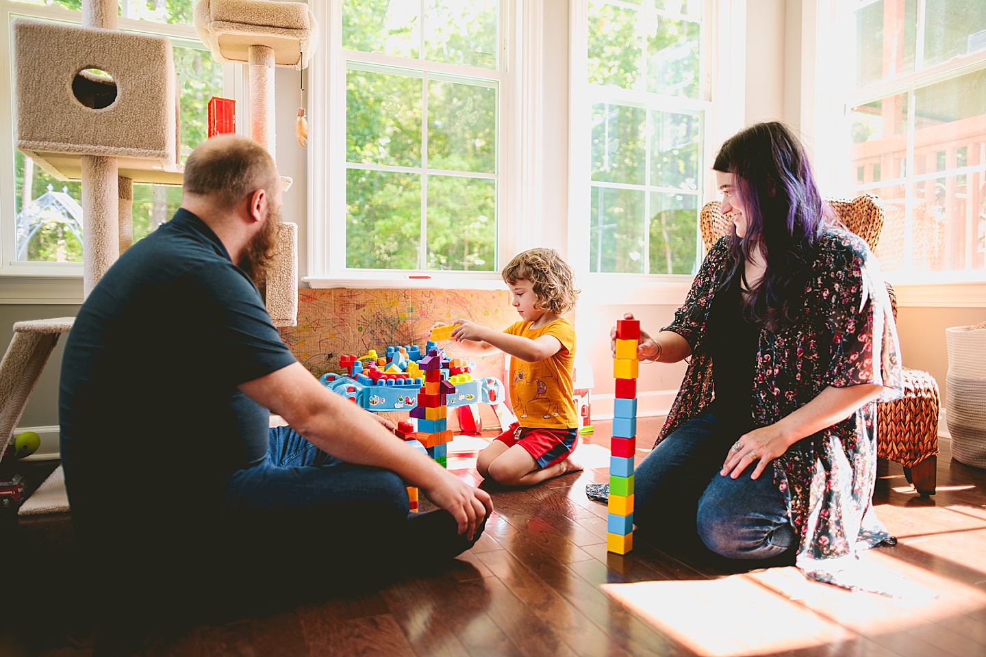 Family playing with blocks in sunroom