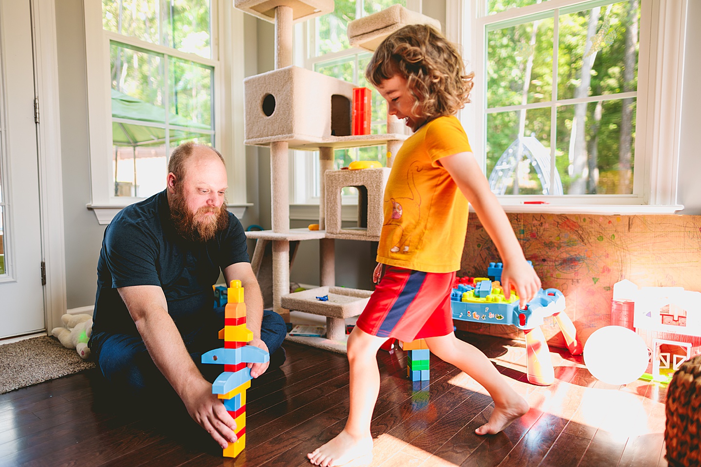 Family playing with blocks in sunroom