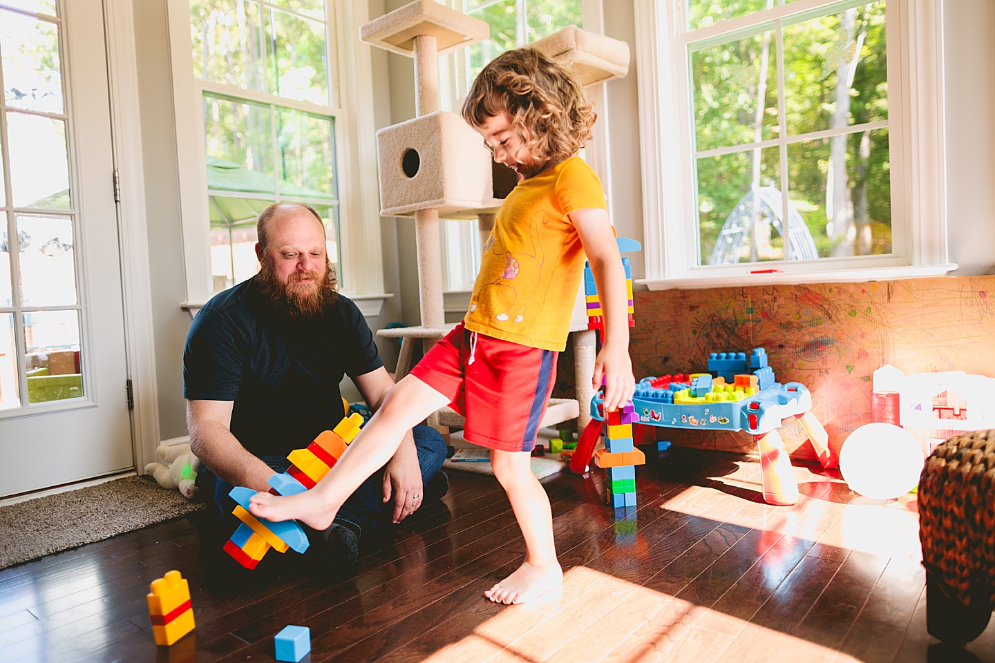 Family playing with blocks in sunroom